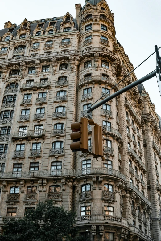 a tall stone building with a traffic light in front