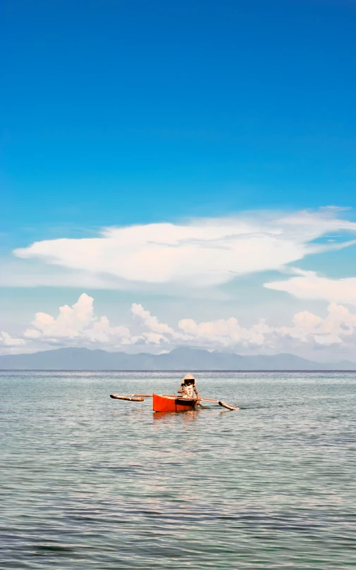 the woman is in the water with her canoe