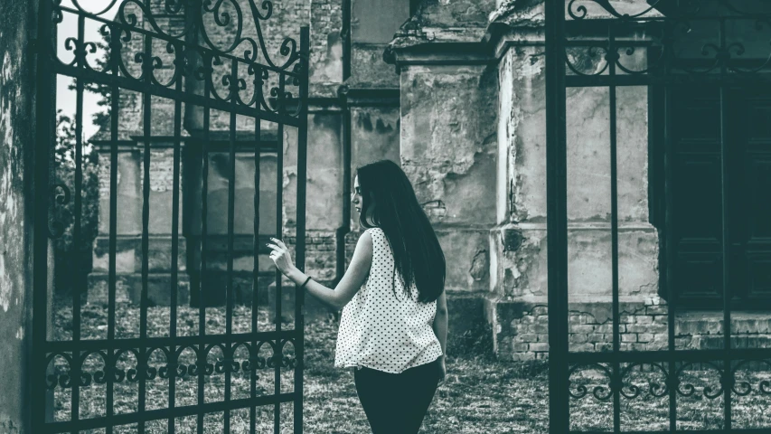 an image of woman looking through a gate