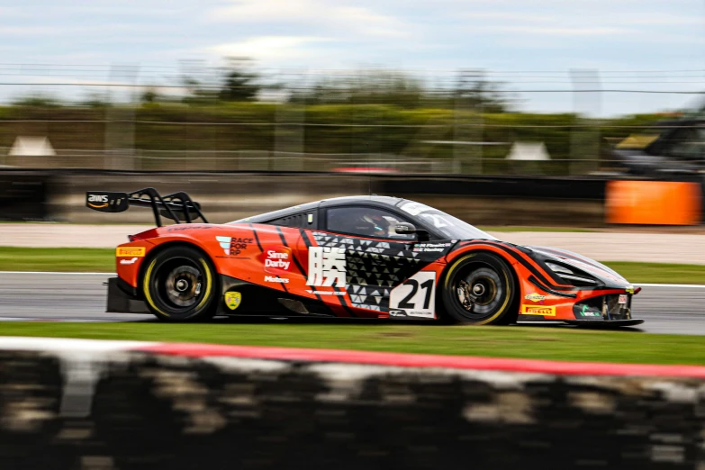 an orange sports car racing on a race track