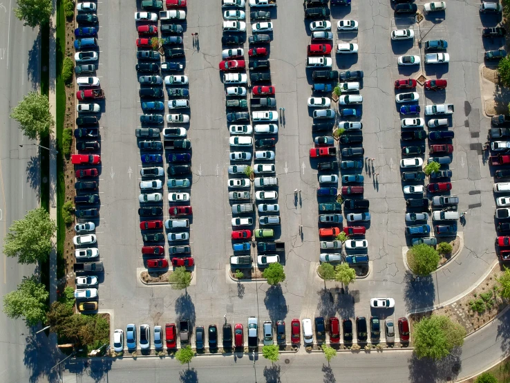 a parking lot full of cars and trees