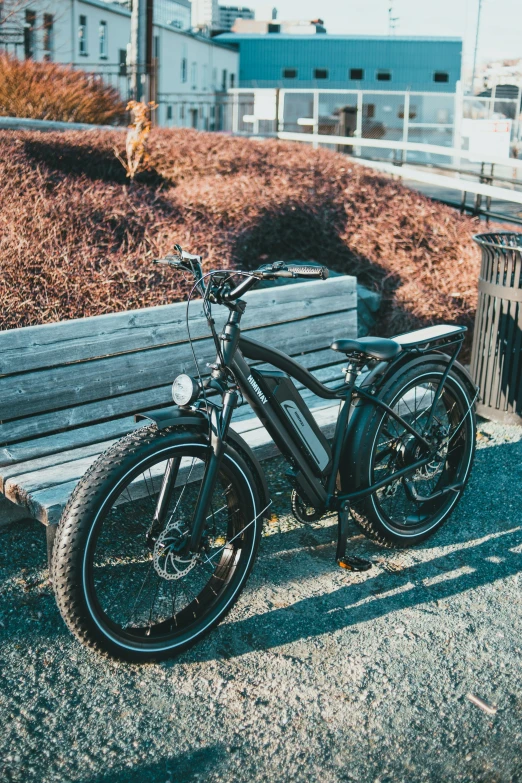 a bicycle sitting up against a wooden park bench