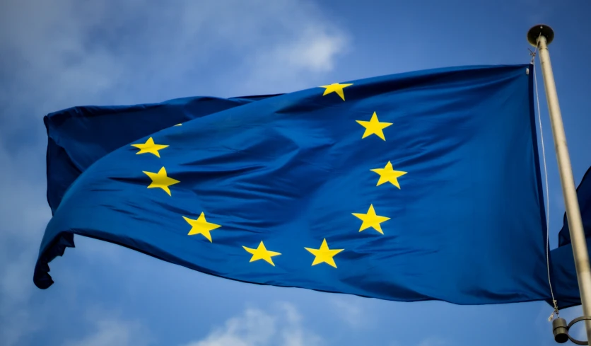an european union flag is flying high in the sky