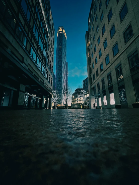 a view from a walkway looking at skyscrs at night