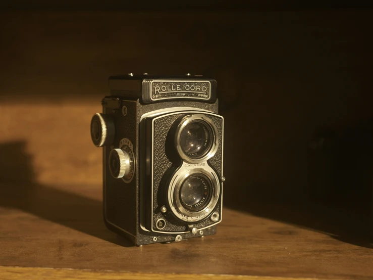 an old fashioned camera on a wooden surface