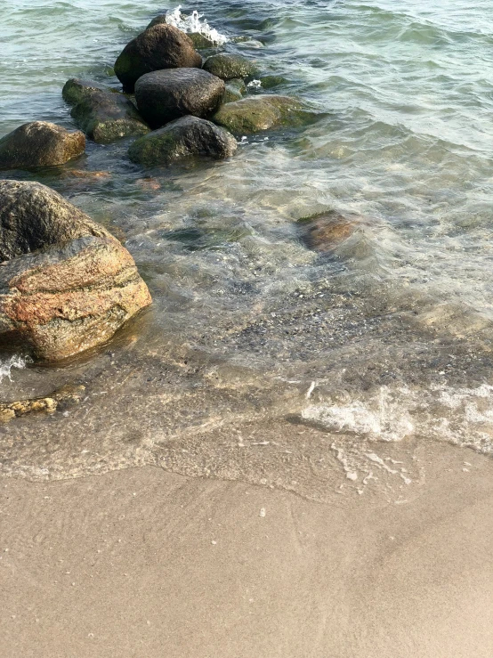 an open ocean with rocks in the water