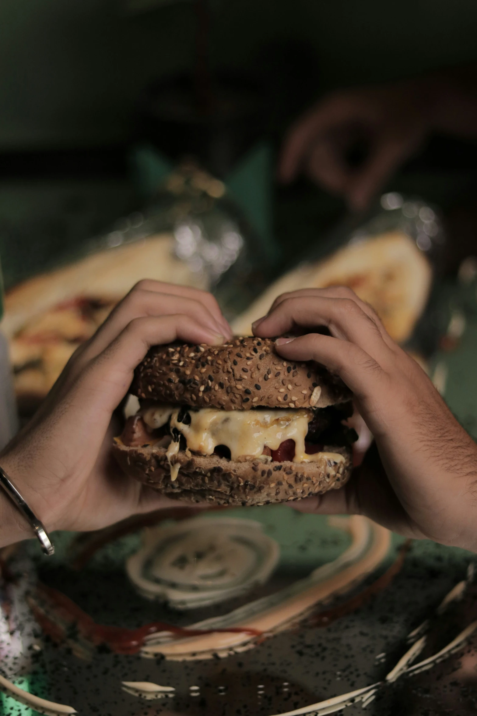 a person making a sandwich with different toppings