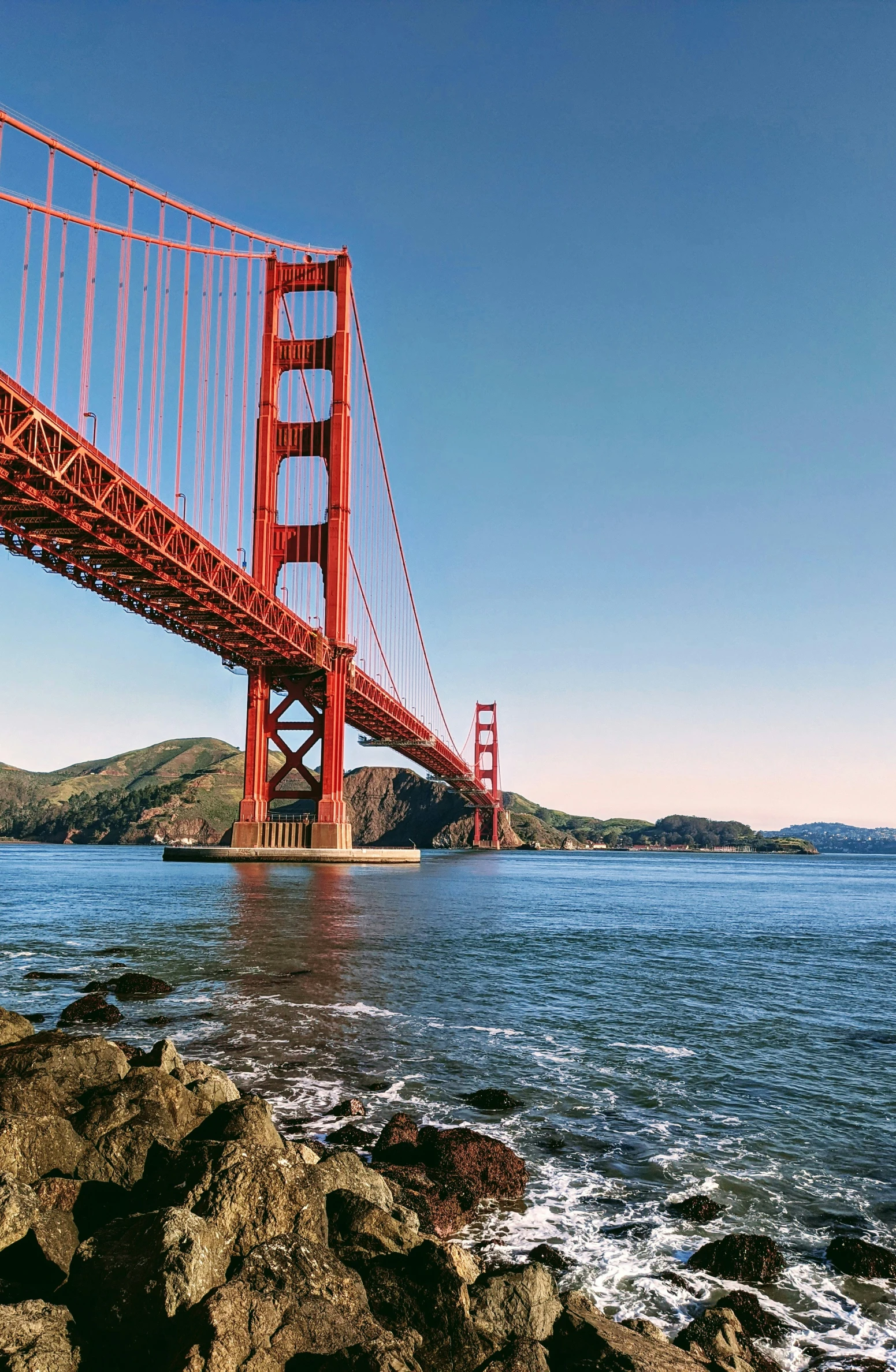 a very large suspension bridge spanning over a big body of water