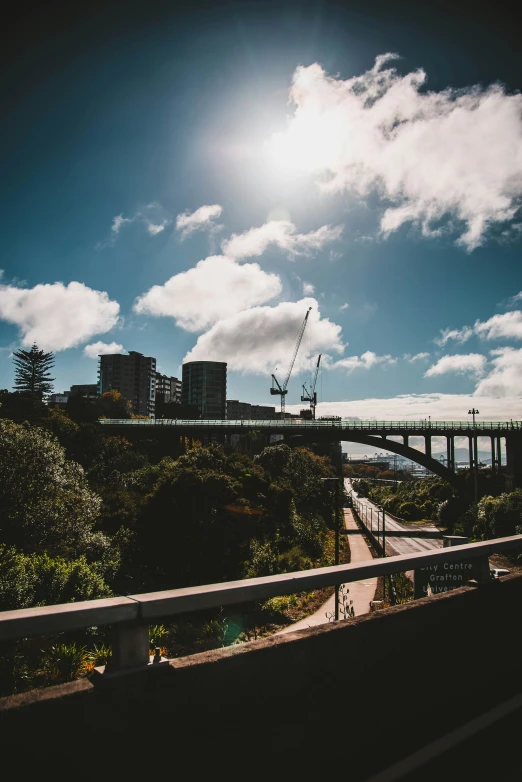 bridge over river with city landscape in background