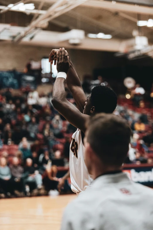 a person up high to the air during a basketball game