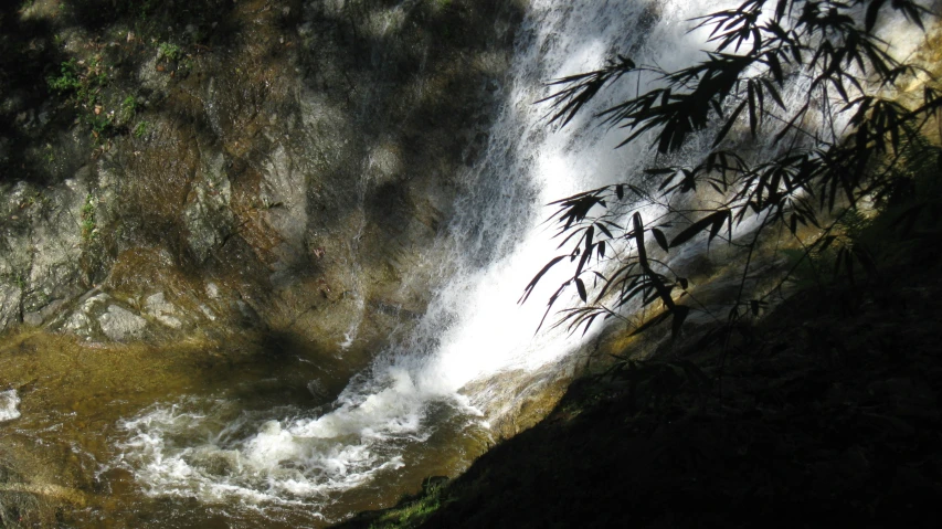 the water is flowing down the side of a waterfall