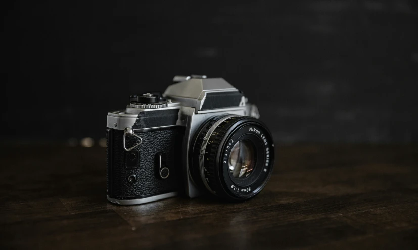 a camera sitting on a table with the light reflected off of it