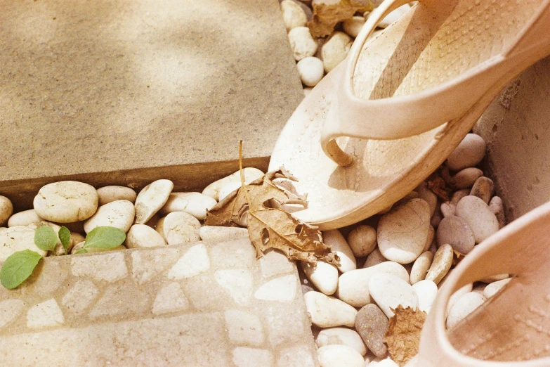 a pair of shoes sitting on top of a stone covered floor