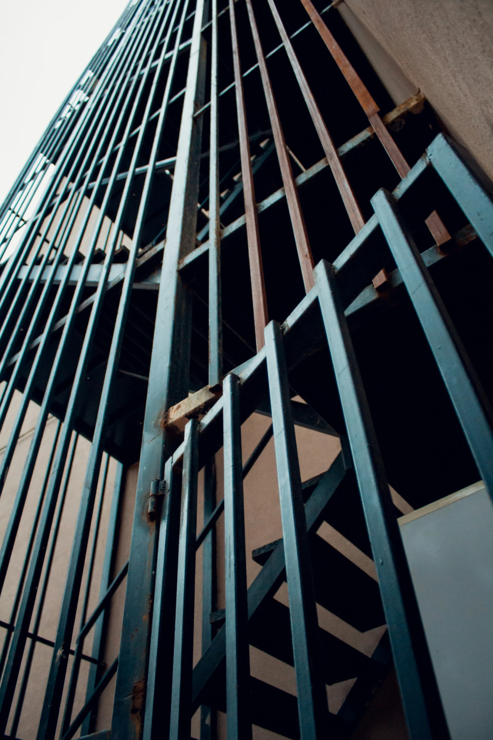 metal and wooden structure of skyscrs seen from below