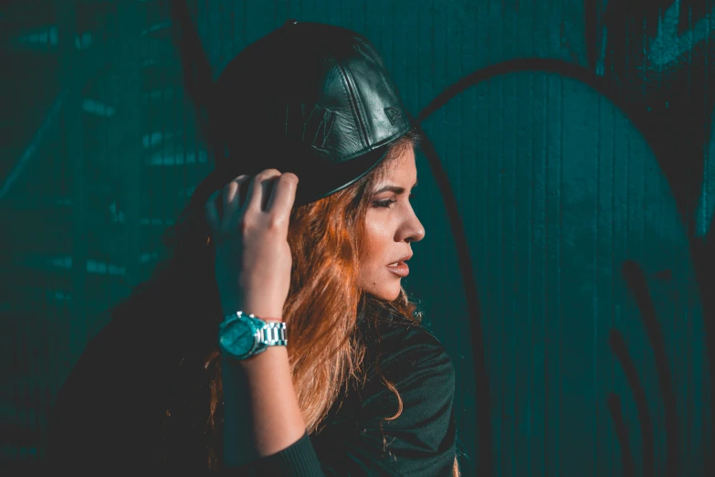 a woman with red hair wearing a leather hat