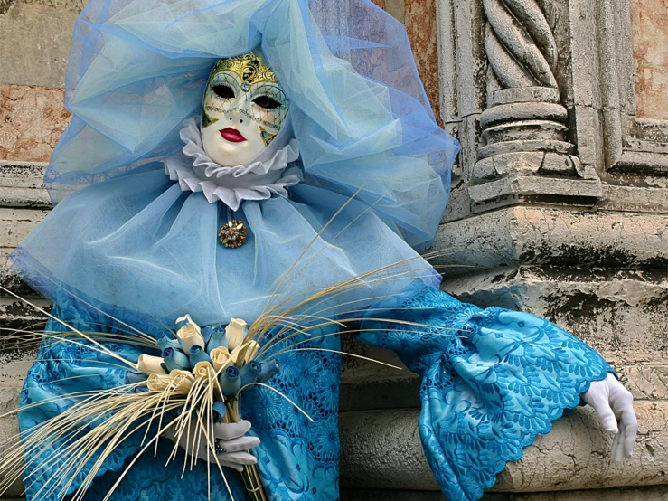 a couple of masks in blue clothing and flowers