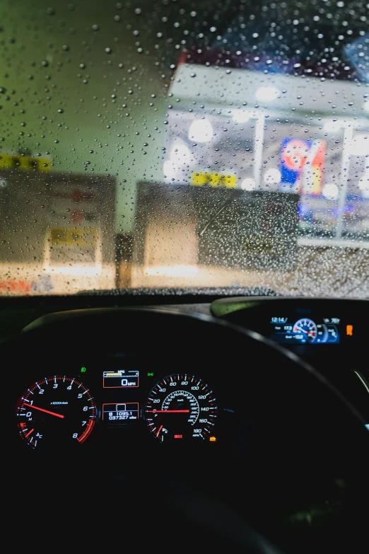 a windshield with a meter and dashboard light