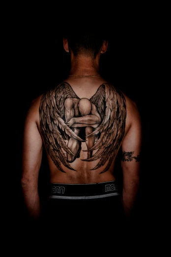 the back of a man's body has wings drawn