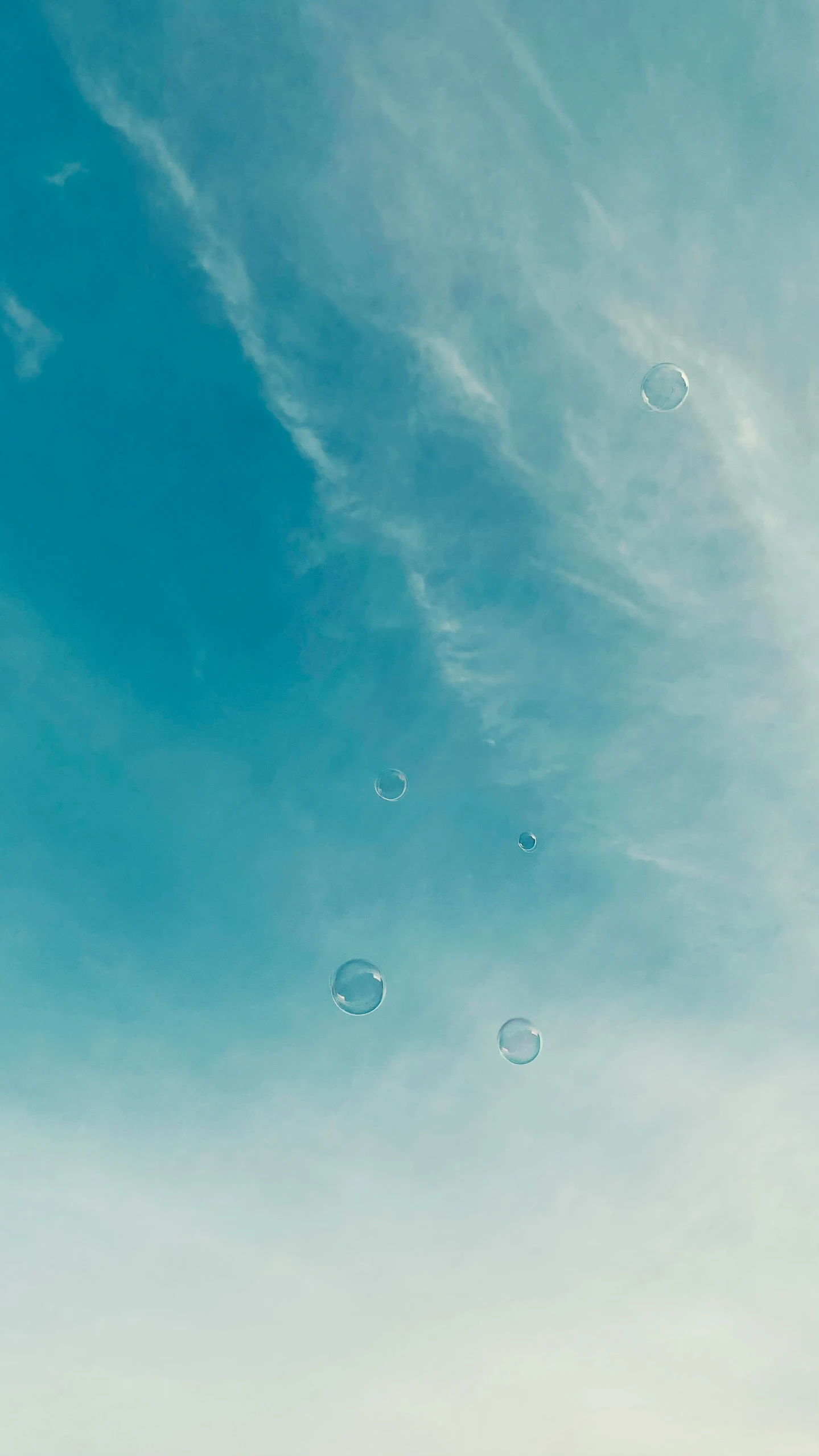 several bubbles are flying in the sky on a clear day