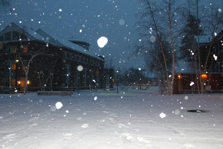 a building at night covered in snow on a snowstorm