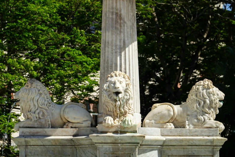 a marble lion sculpture in front of a pillar