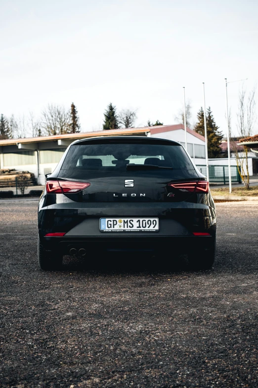 a black sports car parked in front of a building