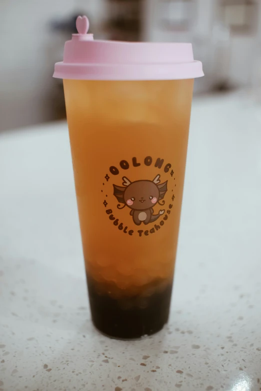 a cup of coffee with a small bear on the side