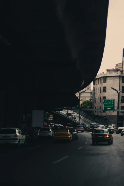 traffic at a junction on the road with tall buildings