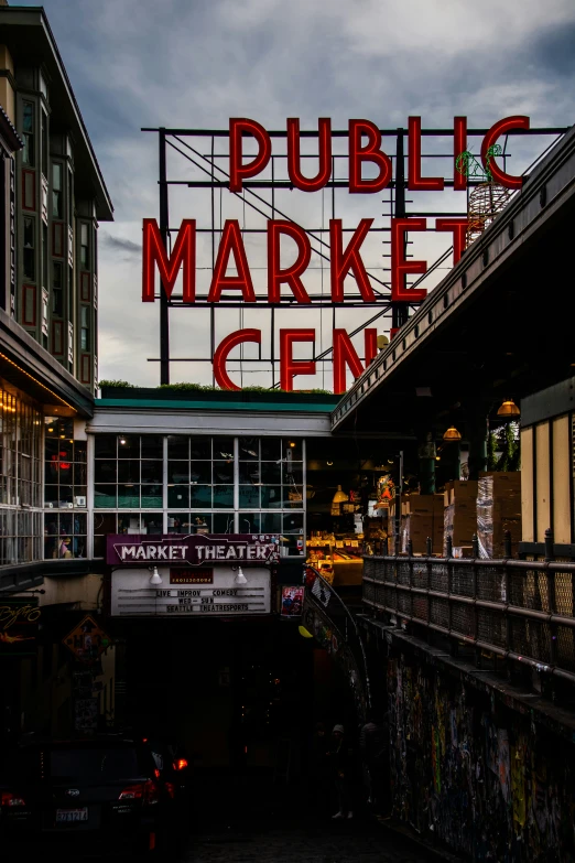 a large sign over a walkway in a shopping mall