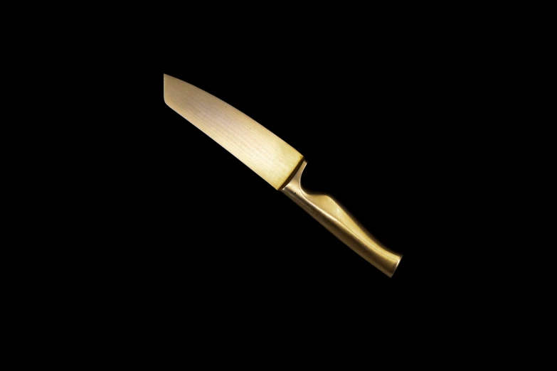 a knife is sitting on a black surface