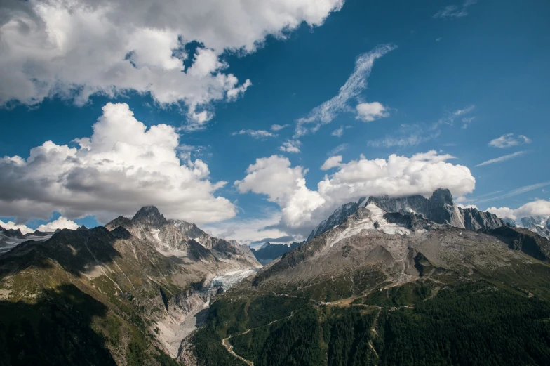 a mountain landscape with green trees and mountains