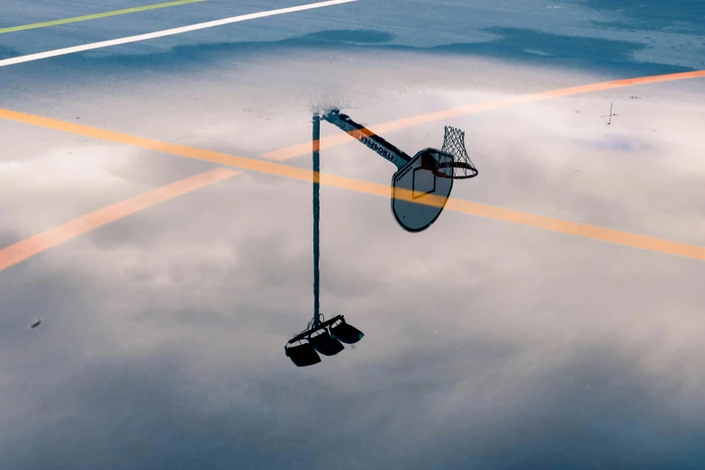 a basketball goal and some buckets floating in the water