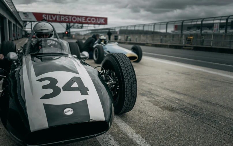 a racer car sitting in the pits at silverstone speedway