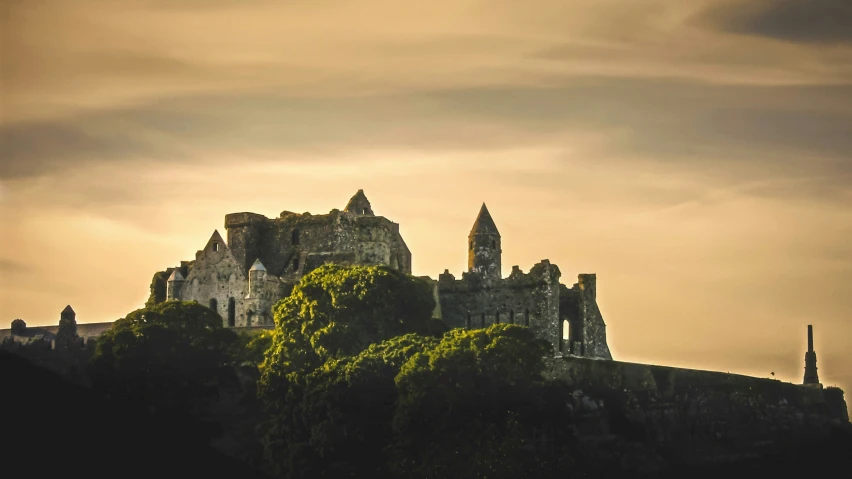 a castle like structure is perched on top of a hill