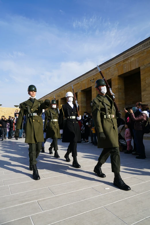 two uniformed officers marching in formation