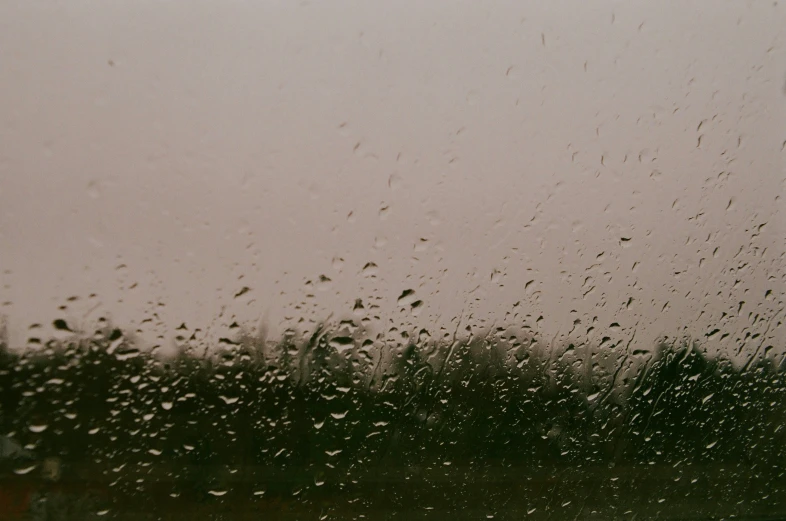 a window covered in rain on a rainy day