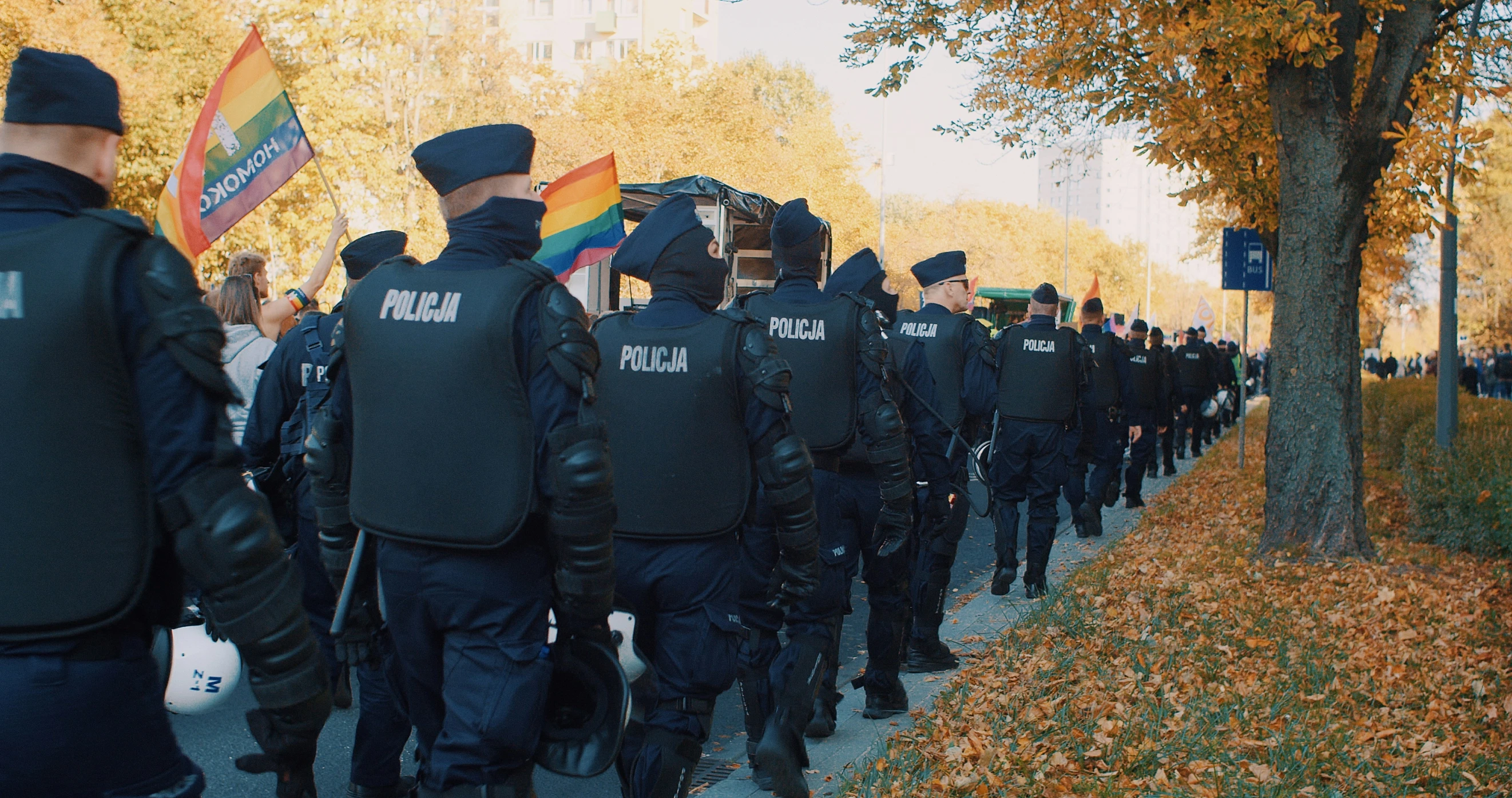 the policemen are marching with the flag of each other