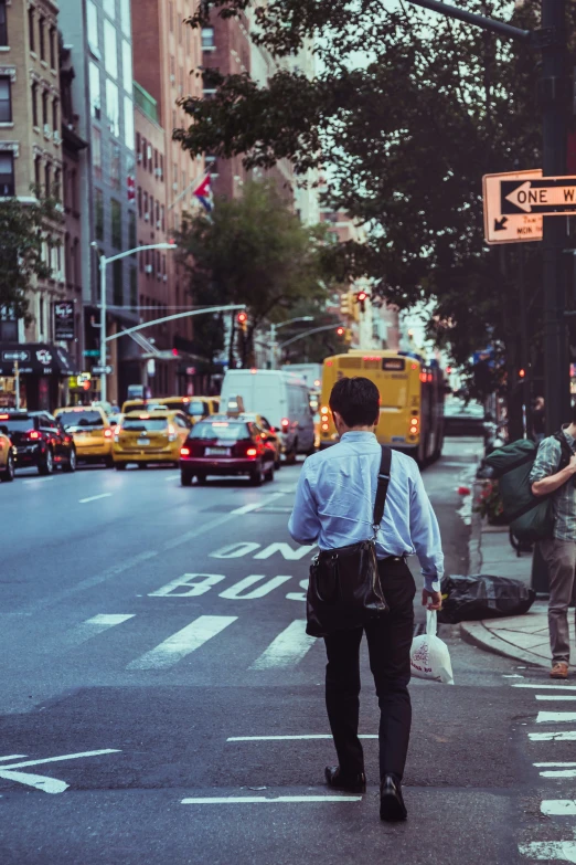 a man is walking on the side of the road