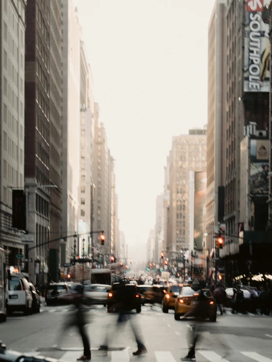 two people riding skateboards down the middle of a city street