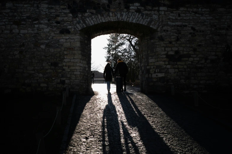 people standing in an entrance on a walkway