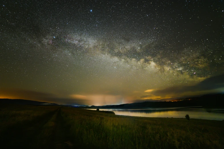 people are silhouetted by the stars in the night sky