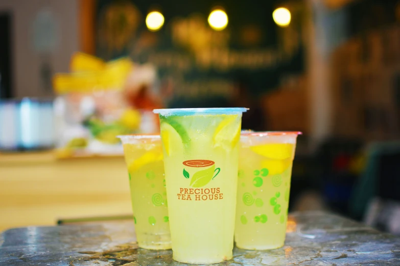 two plastic cups sitting on a table in front of a counter