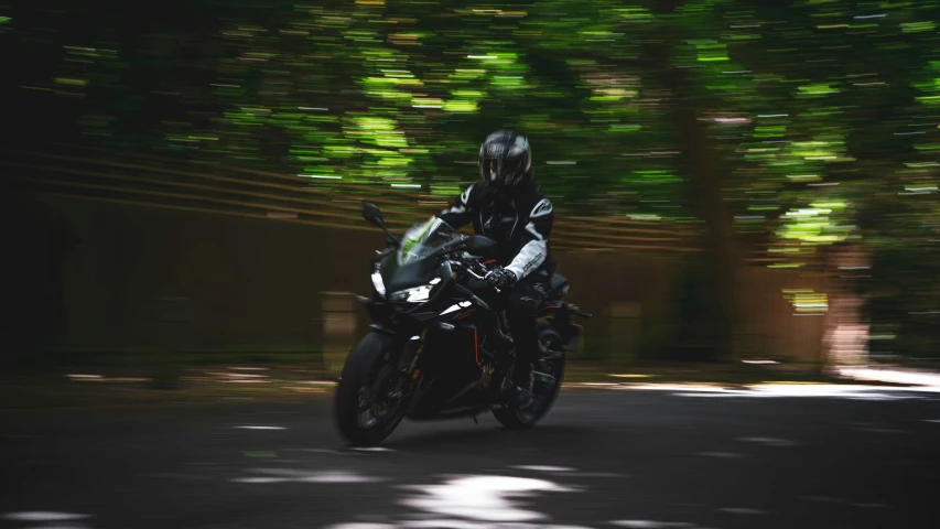 a person riding on a motorcycle in the middle of the road