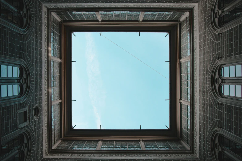 looking up into the sky through an old window