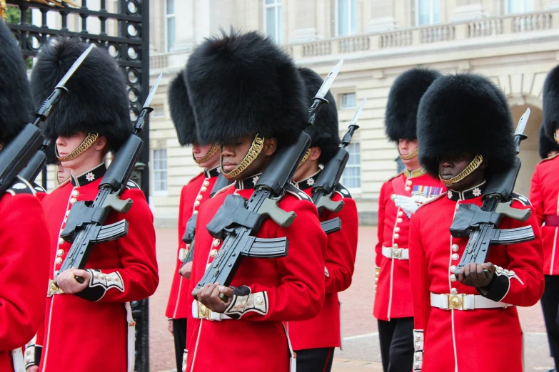 a group of men in uniform carrying guns