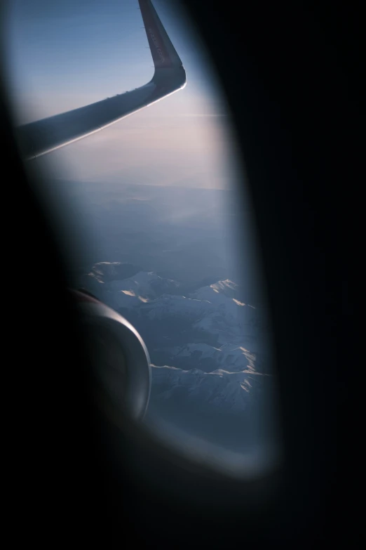 an airplane wing is seen through a window