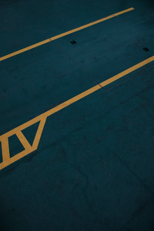 an empty parking lot with a yellow line that has the words no parking on it