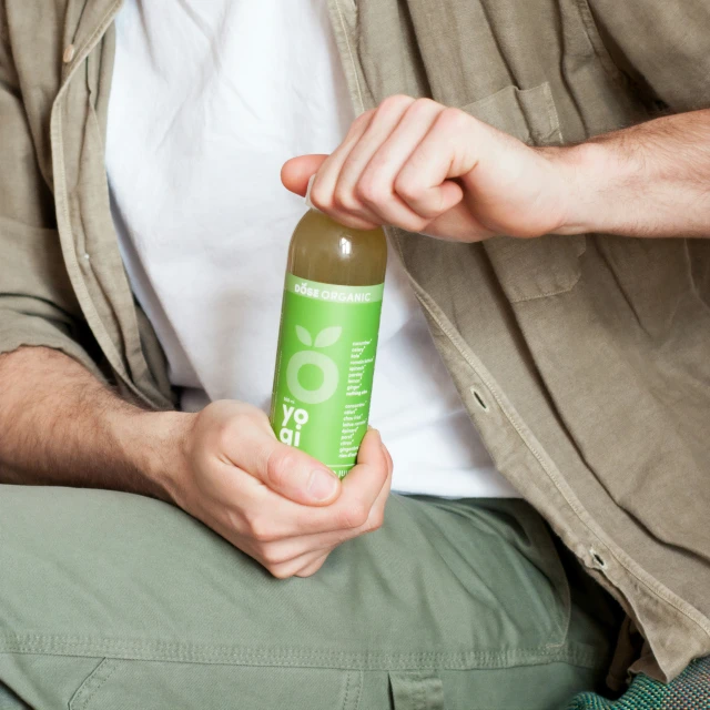 a man sitting on a bench with a bottle in his hand