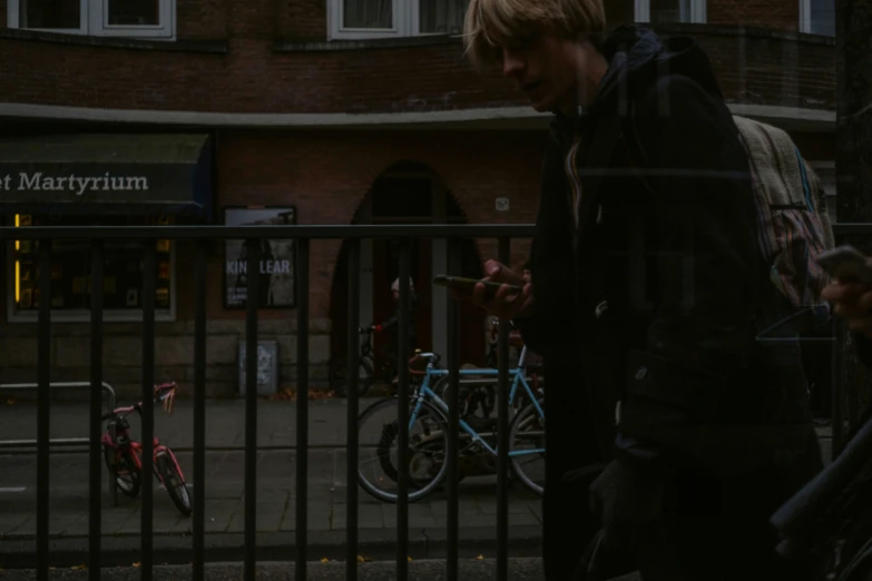 a man is walking on the street smoking a cigarette