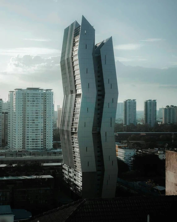 a tall building with multiple windows near another building